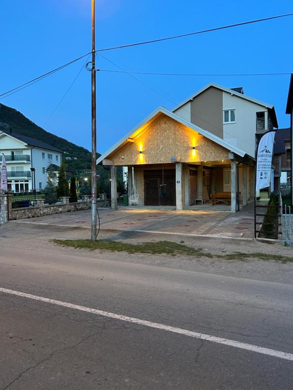 a building on the side of a street at Lone Star Apartments in Gusinje
