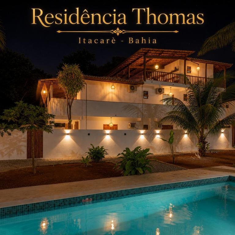 a resort with a swimming pool in front of a building at Residência Thomas in Itacaré