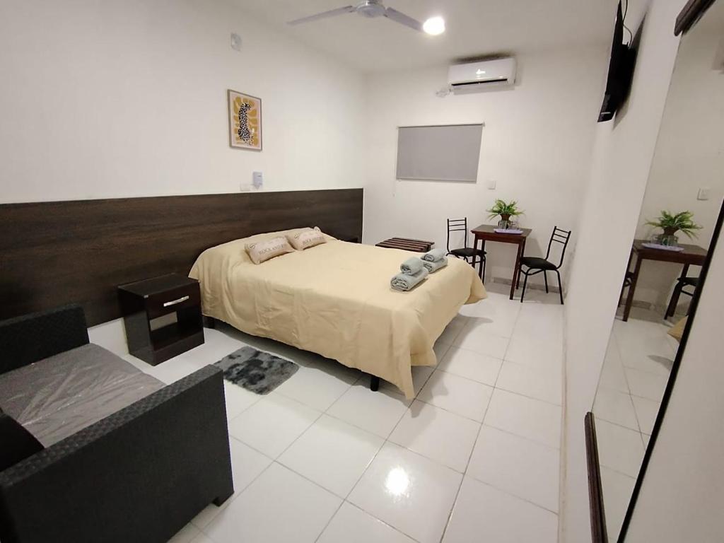 a bedroom with a bed and a flat screen tv at Alojamiento Ruta 51 in La Banda