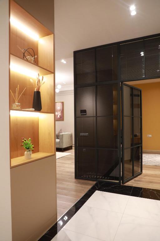 a lobby with a large glass elevator in a building at Tashkent city Gardens E2 block in Tashkent