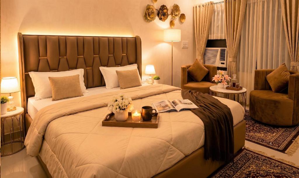 a bedroom with a large bed with a tray on it at Peaceful Studio with Kitchen in New Delhi