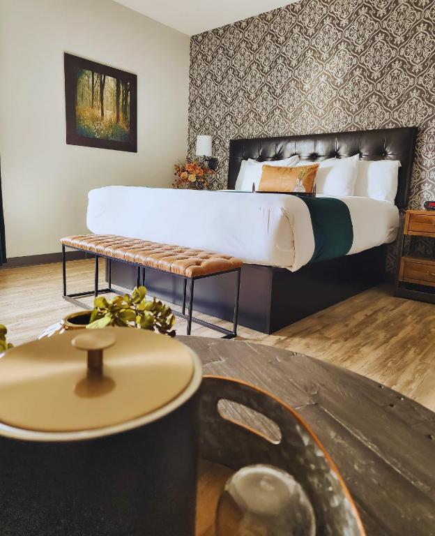 a bedroom with a large bed and a table at Waterfront Hotel in Prairie du Chien