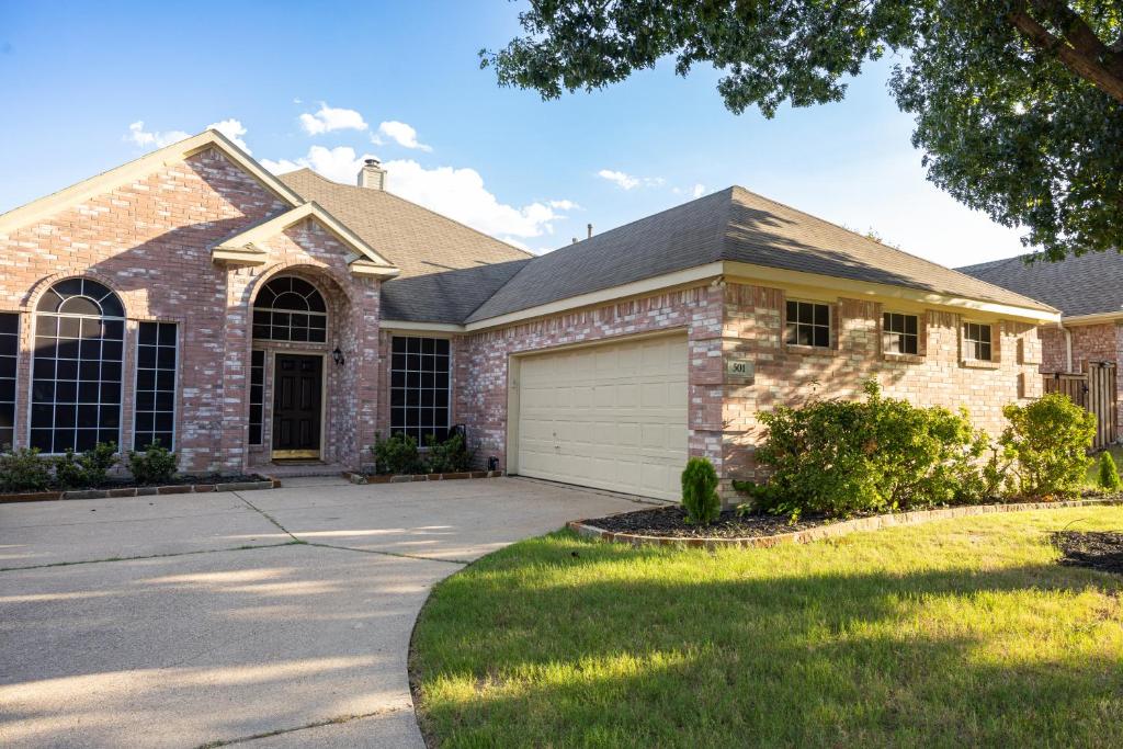 a large brick house with a garage at Bluebonnet Retreat in Flower Mound