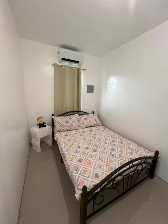 a small bedroom with a bed in a room at Alexeis Place in Manolo Fortich