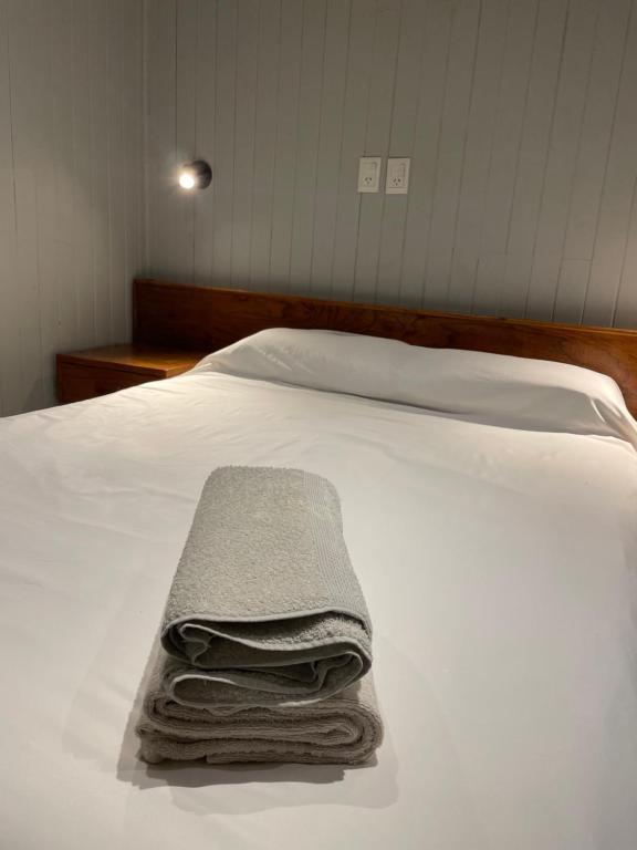a pile of towels sitting on top of a bed at Casa Calma in Eldorado