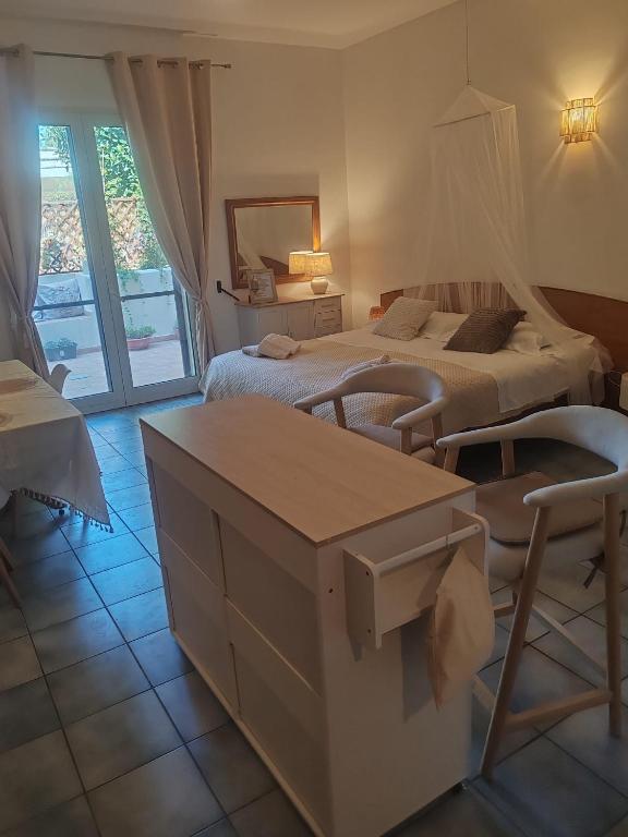 a hotel room with two beds and a table at Salento Garden Relax in Merine