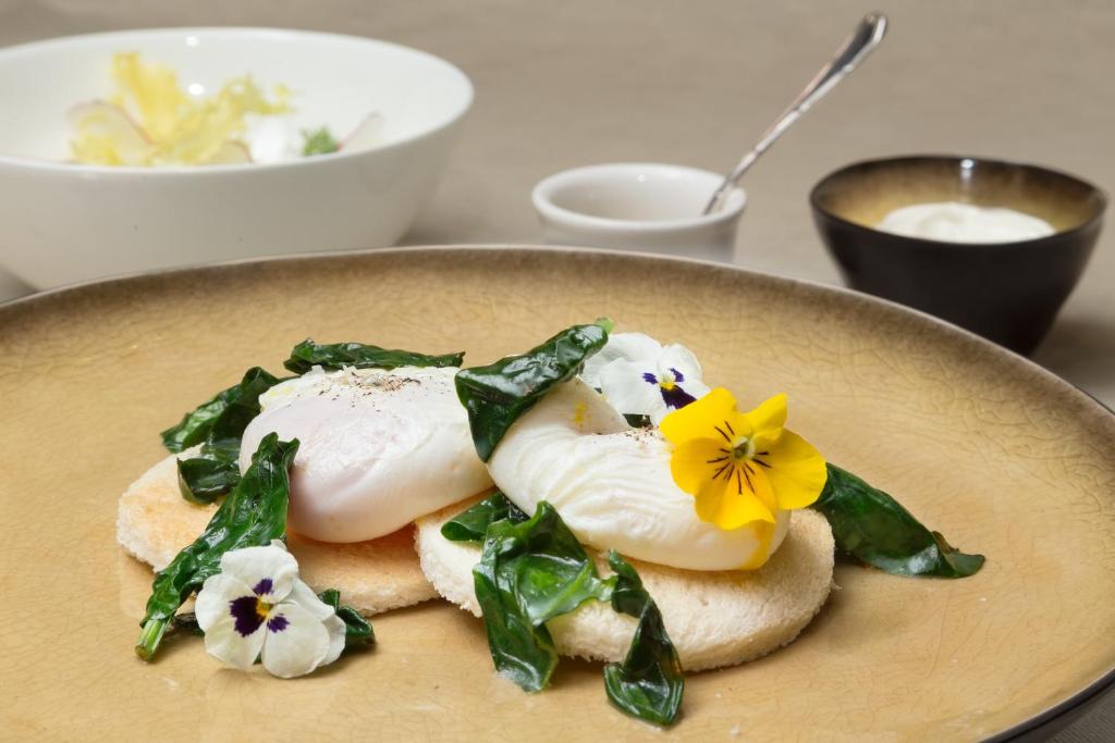 a plate of food with vegetables and flowers on it at Palazzo Venart Luxury Hotel in Venice