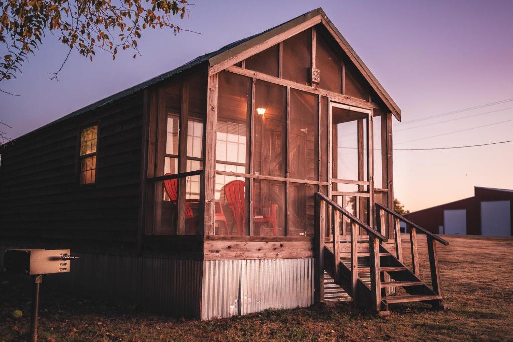 a small house with a red chair in it at Lakeview Cedar Cabin - 6 in Mead