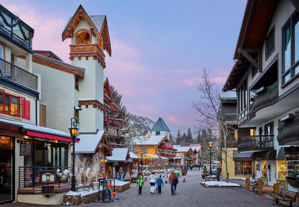 a group of people walking down a street in a town at Christiania Lodge in Vail