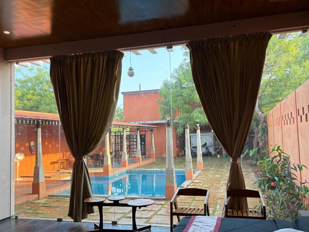 a view of a pool from the window of a house at Villa Saffron Luxury Pvt Pool in Pondicherry