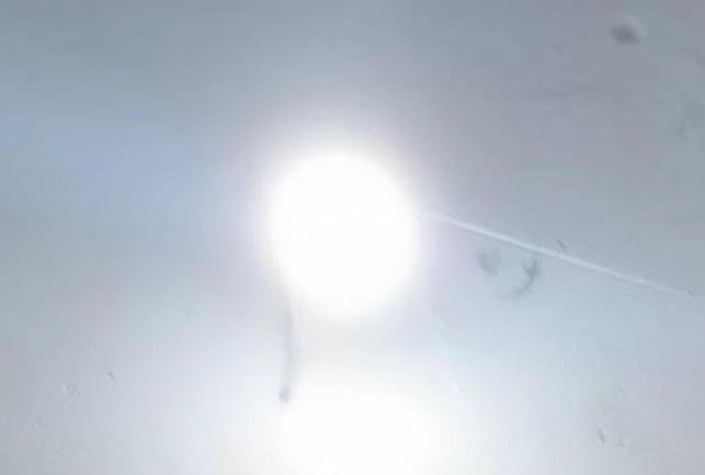 a window with a light shining through it at J'adore House in Abémé