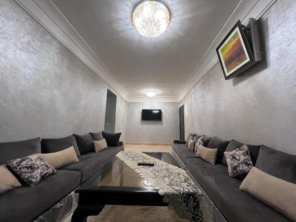 a living room with a couch and a table at Cozy Appartement for vacation in Agadir