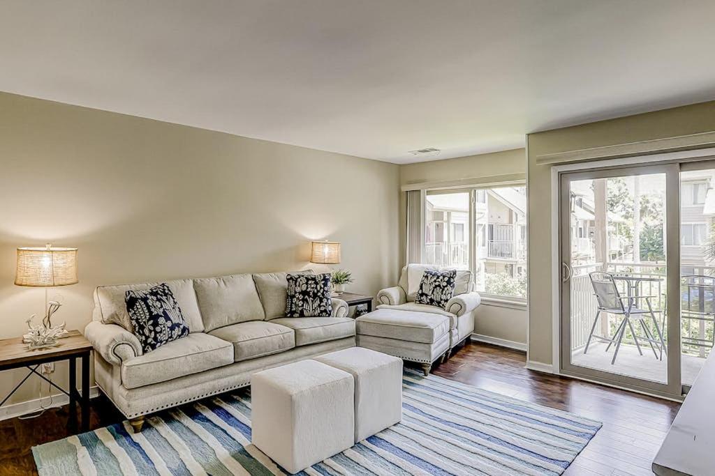 a living room with a couch and a table at Courtside 56 in Hilton Head Island