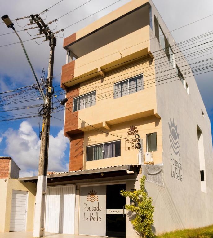 a building with a sign in front of it at Pousada La Belle in Maragogi