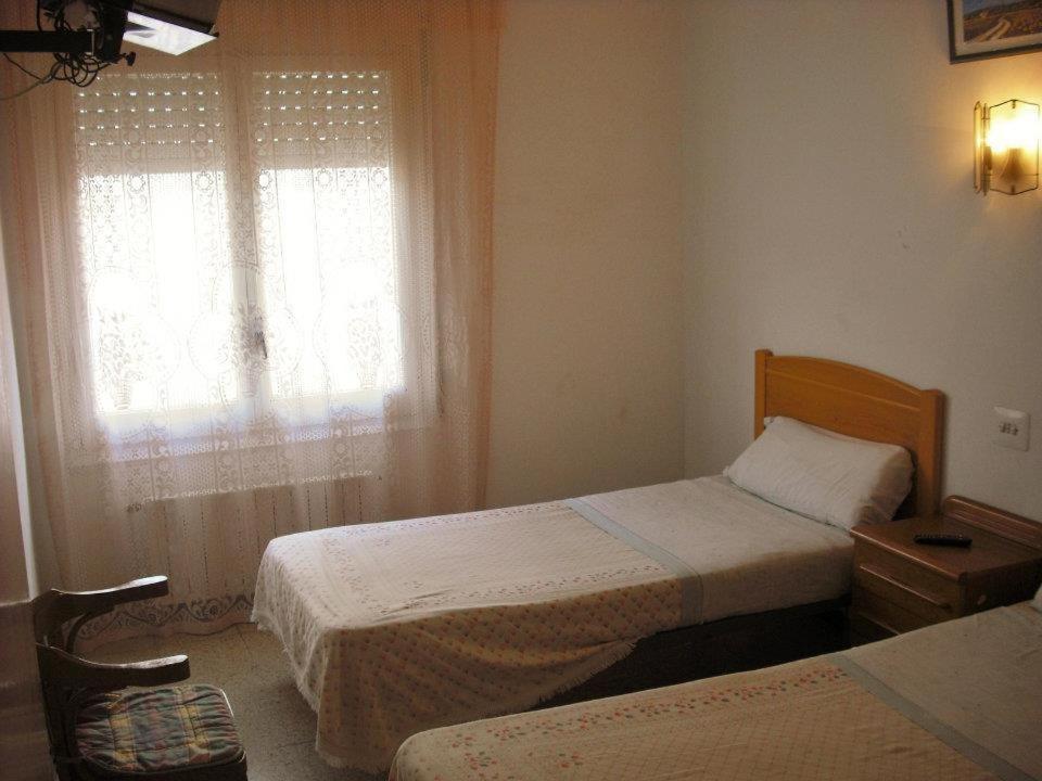 Ένα ή περισσότερα κρεβάτια σε δωμάτιο στο Hostal Cassa