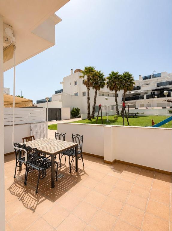 a patio with a table and chairs on a balcony at Skandi home in Gran Alacant