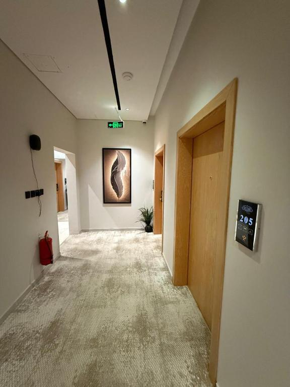 an empty hallway in an office building with a picture on the wall at Bright Moon in Al-ʿUla