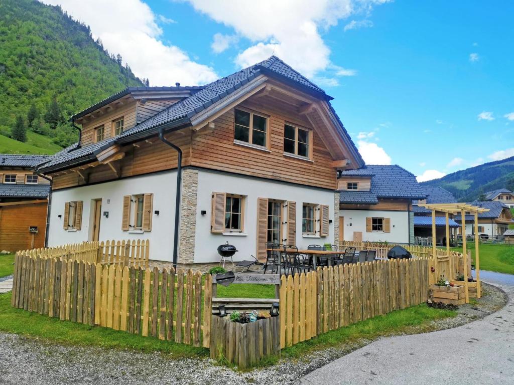 a house with a wooden fence in front of it at Ebersberger in Donnersbachwald