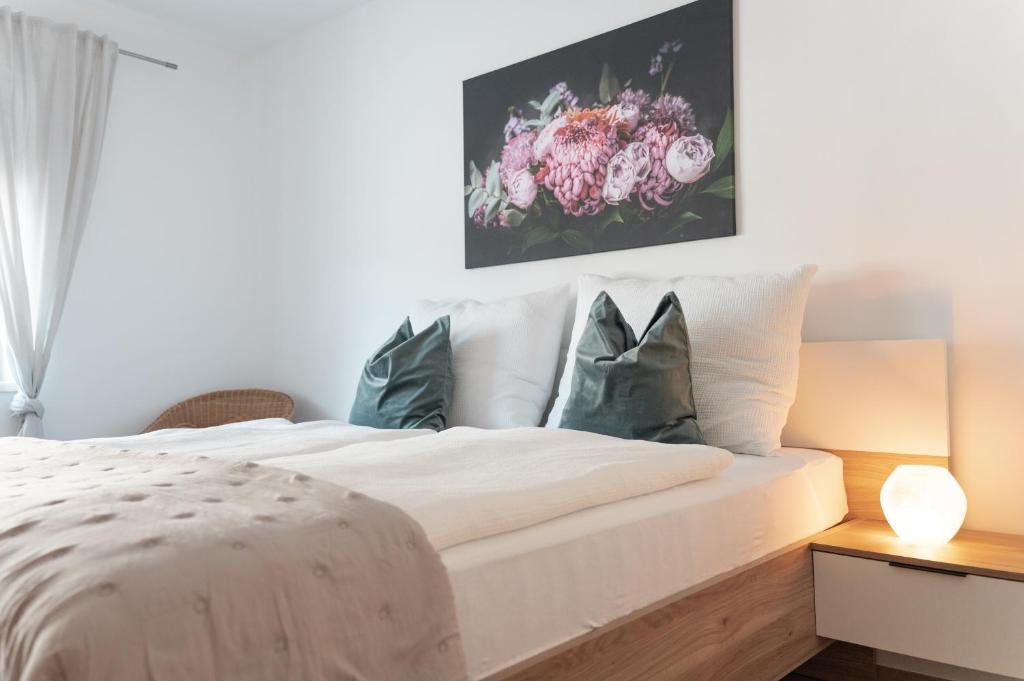 a bedroom with a large white bed with pillows at Pirkners Home in Sooss