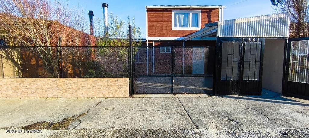 a gate to a house with a fence at Yahweh in Río Grande