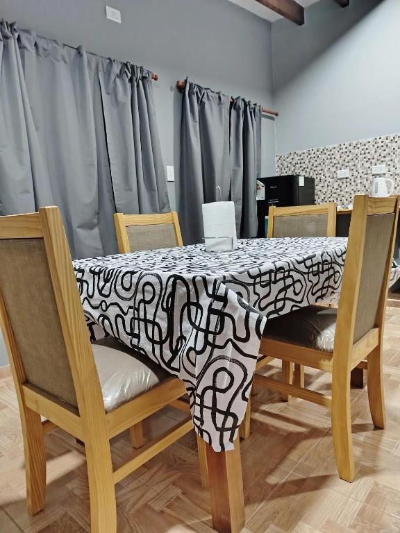 a table with a black and white table cloth on it at Alojamiento Quilla-Unta in Fiambalá
