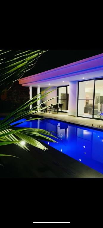 a house with a swimming pool in front of it at Amazone in Ngaparou