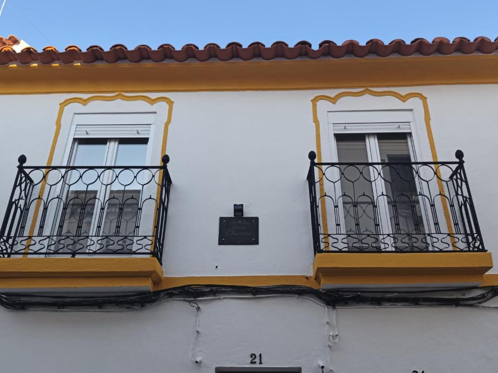 two balconies on the side of a building at Flor de Charme in Campo Maior