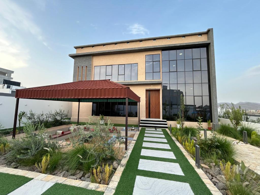 a building with a walkway in front of it at Rawnaq aljabal chalet in Qurayyah