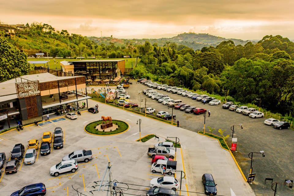 an aerial view of a parking lot with cars parked at HOTEL ROMA VIp in Pereira