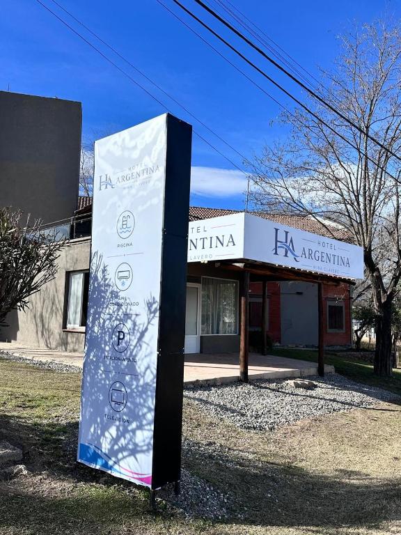 a sign in front of a building at Hotel Argentina in Mina Clavero