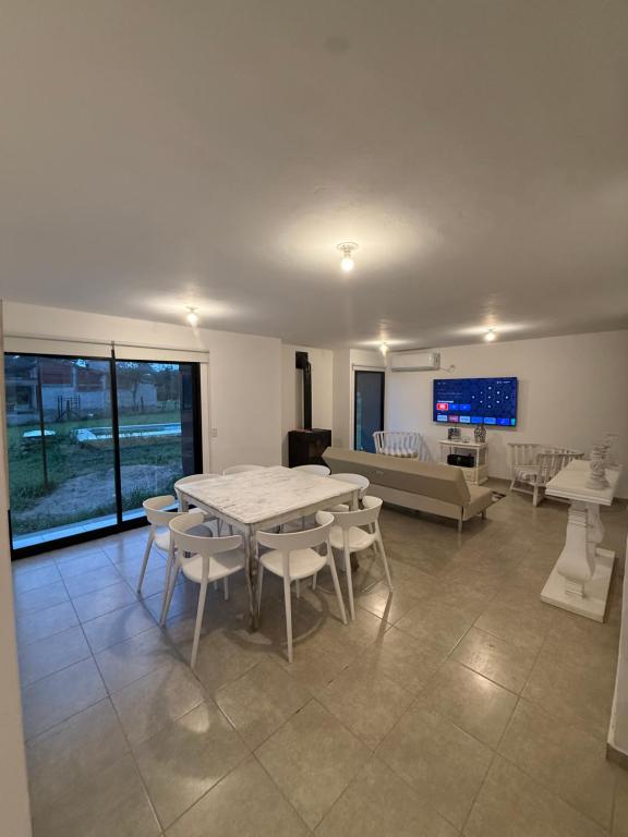 a living room with a table and chairs and a couch at Casa Marti in Los Reartes