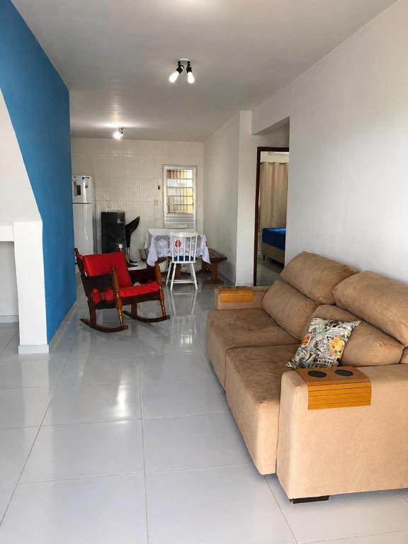 a living room with a couch and a table at Refúgio em Jacumã Conforto, Tranquilidade e Praia in Conde