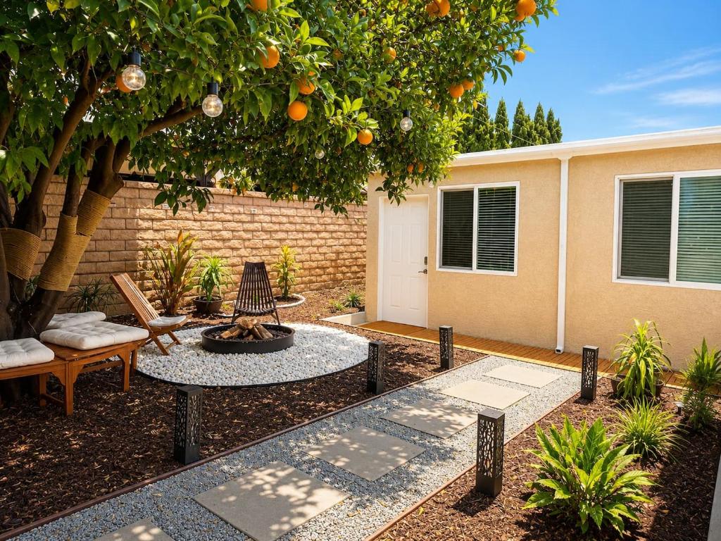 a backyard with a fire pit and an orange tree at Tiny Studio in Orange Garden in Los Angeles