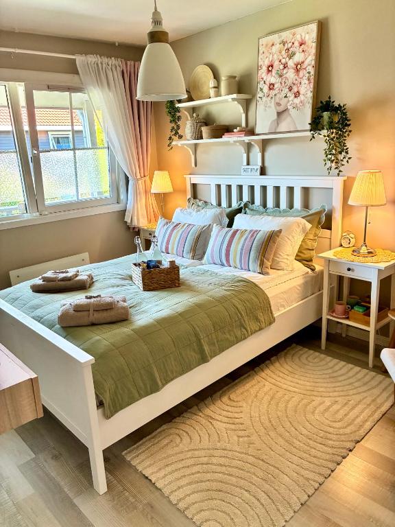 a bedroom with a large white bed in a room at Home between flights Gardermoen in Jessheim