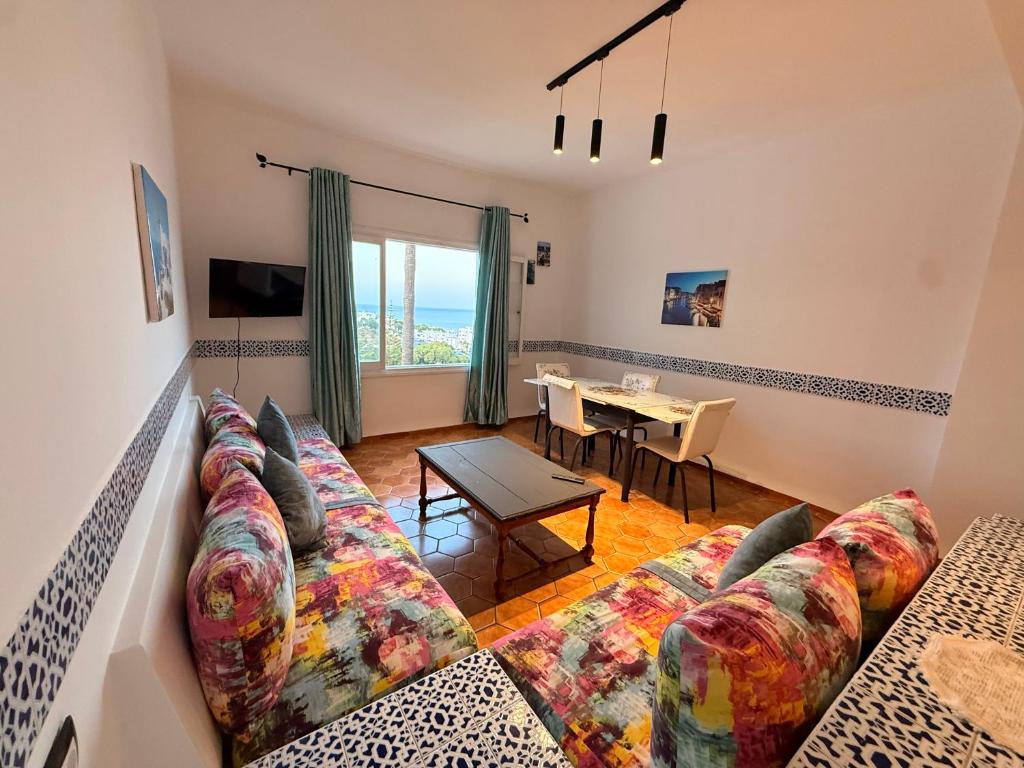 a living room with a couch and a table at Résidence CHATT C3 in Cabo Negro