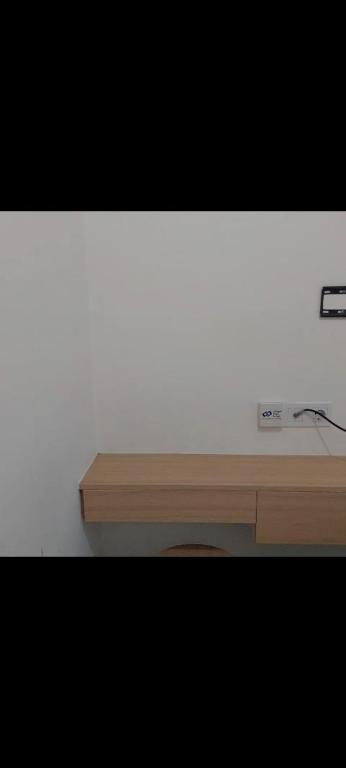 a desk with a computer on top of it at osaka riverview apartment in Rawalumpang