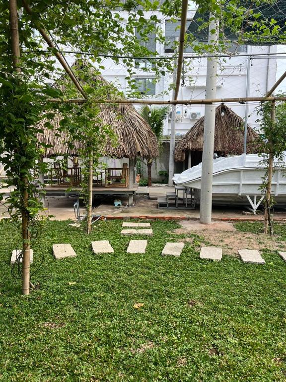 a garden with a building with a roof at Roooftop villa can ho penhouse Tay ninh in Tây Ninh