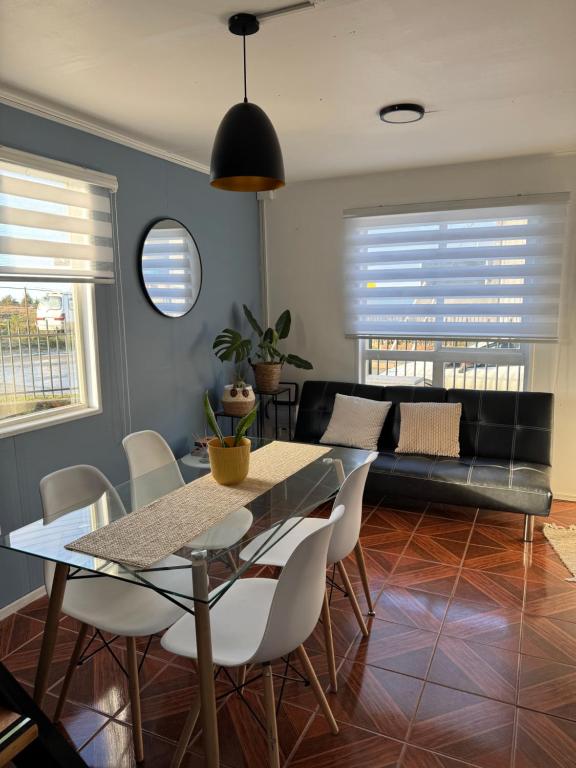 a living room with a table and a couch at Casa 2 dormitorios - Punta Arenas - Río Seco in Punta Arenas