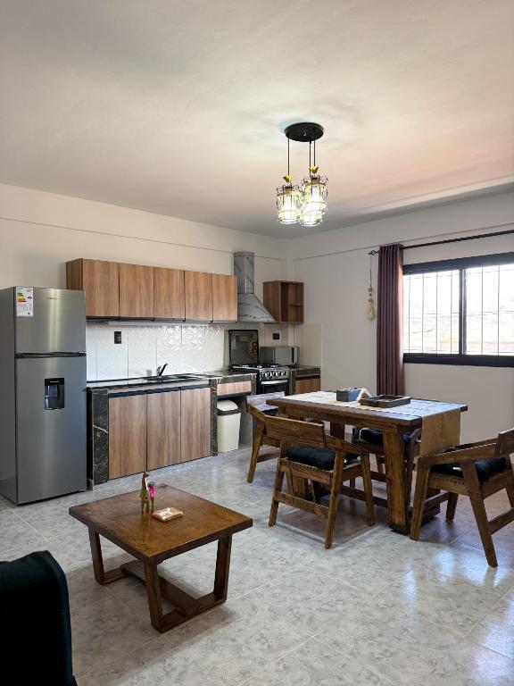 a large kitchen with a table and a dining room at Apart Mirador del Valle in Cachí