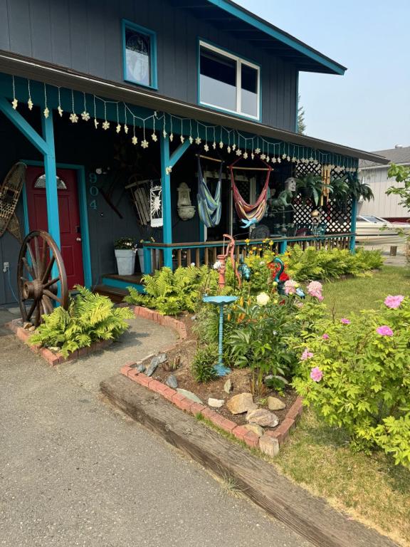 a garden in front of a house with flowers at Northern Knights in Fairbanks