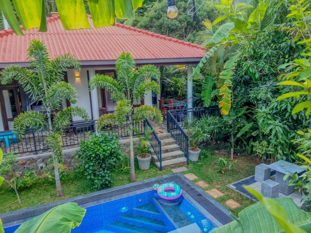a house with a swimming pool in front of a house at White Villa Goyambokka - Private Pool Villa in Tangalle