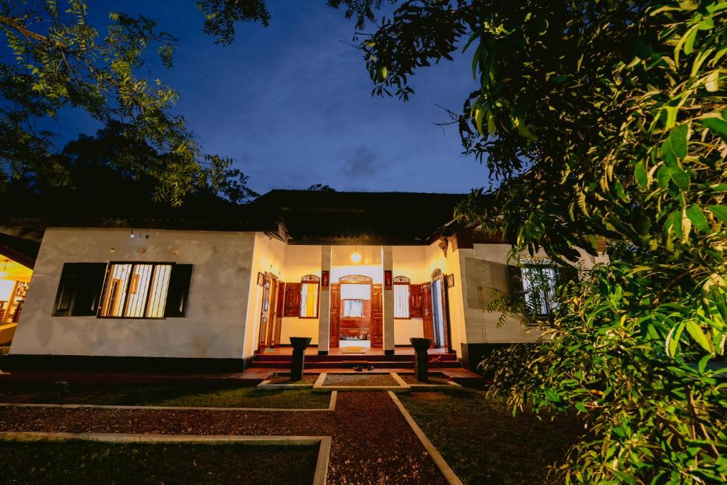 a house with a front door at night at Ayu Ayuruveda Villa in Ittapana