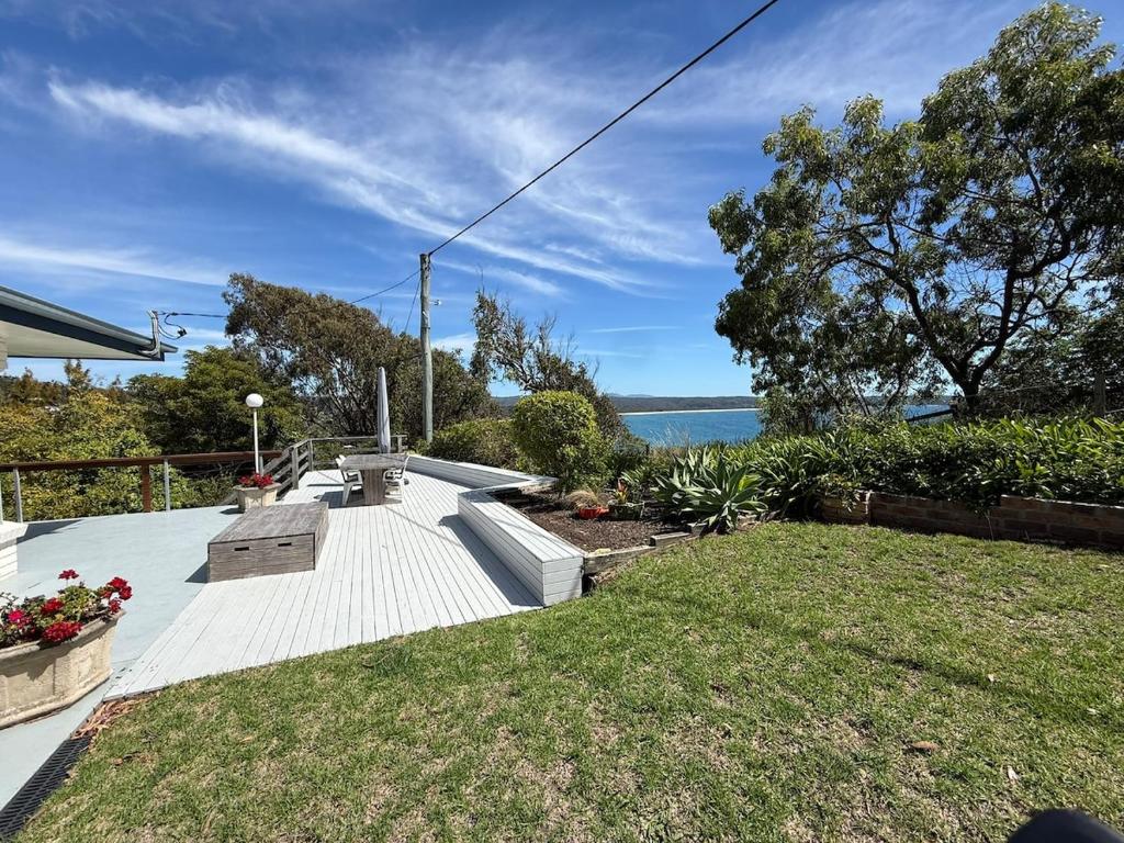 a backyard with a view of the water at Cliff Place in Tathra