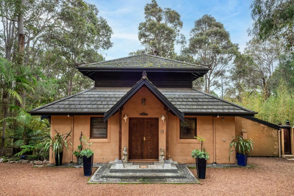 a small house with a black roof at Riveresque - Spa Bath - Forest Views in Margaret River Town