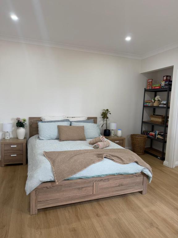 a bedroom with a large bed with blue pillows at Lamington Guesthouse in Kalgoorlie