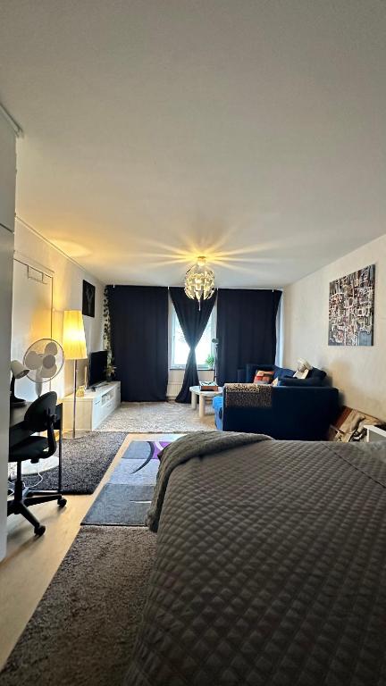 a bedroom with a bed and a living room at kenneth's Home in Stockholm