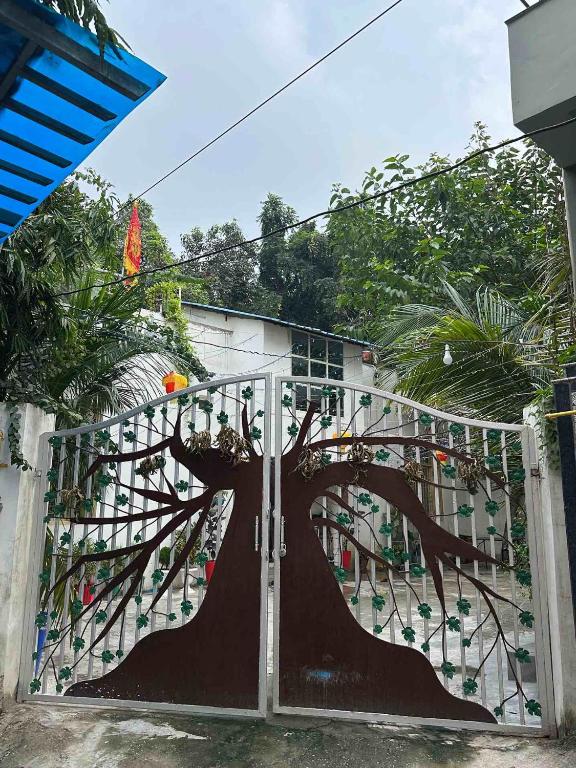 a gate with a tree painted on it at Sadhana kunj in Varanasi