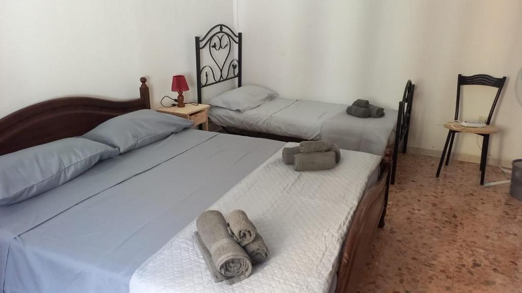 a bedroom with two beds with towels on them at Casa relax Mele in Siniscola
