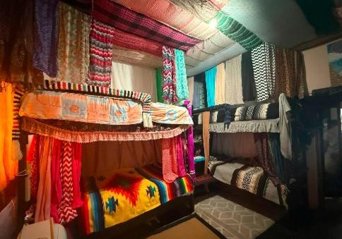 a room with a bed and curtains in a room at My Little Hostel in Monterrey