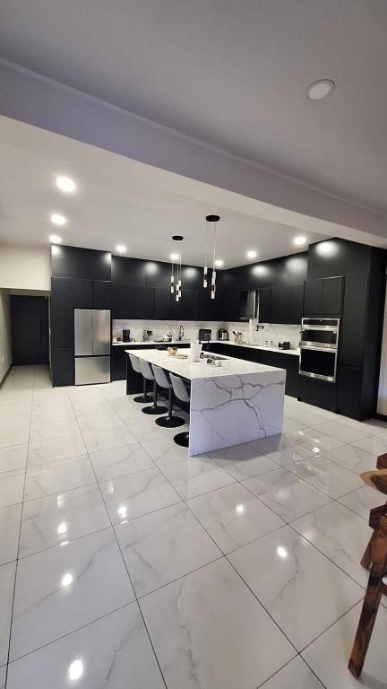 a large kitchen with a large white table in it at Greivin House in Santa María